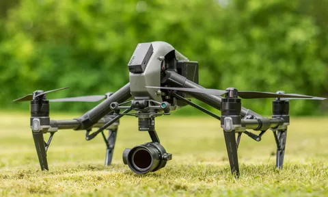 A drone on grass with Remote ID Pro mounted on top